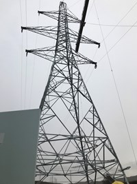View from the ground of a metal transmission tower 