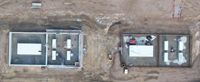An overhead view of two buildings under construction.