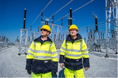engineers with powerlines in background