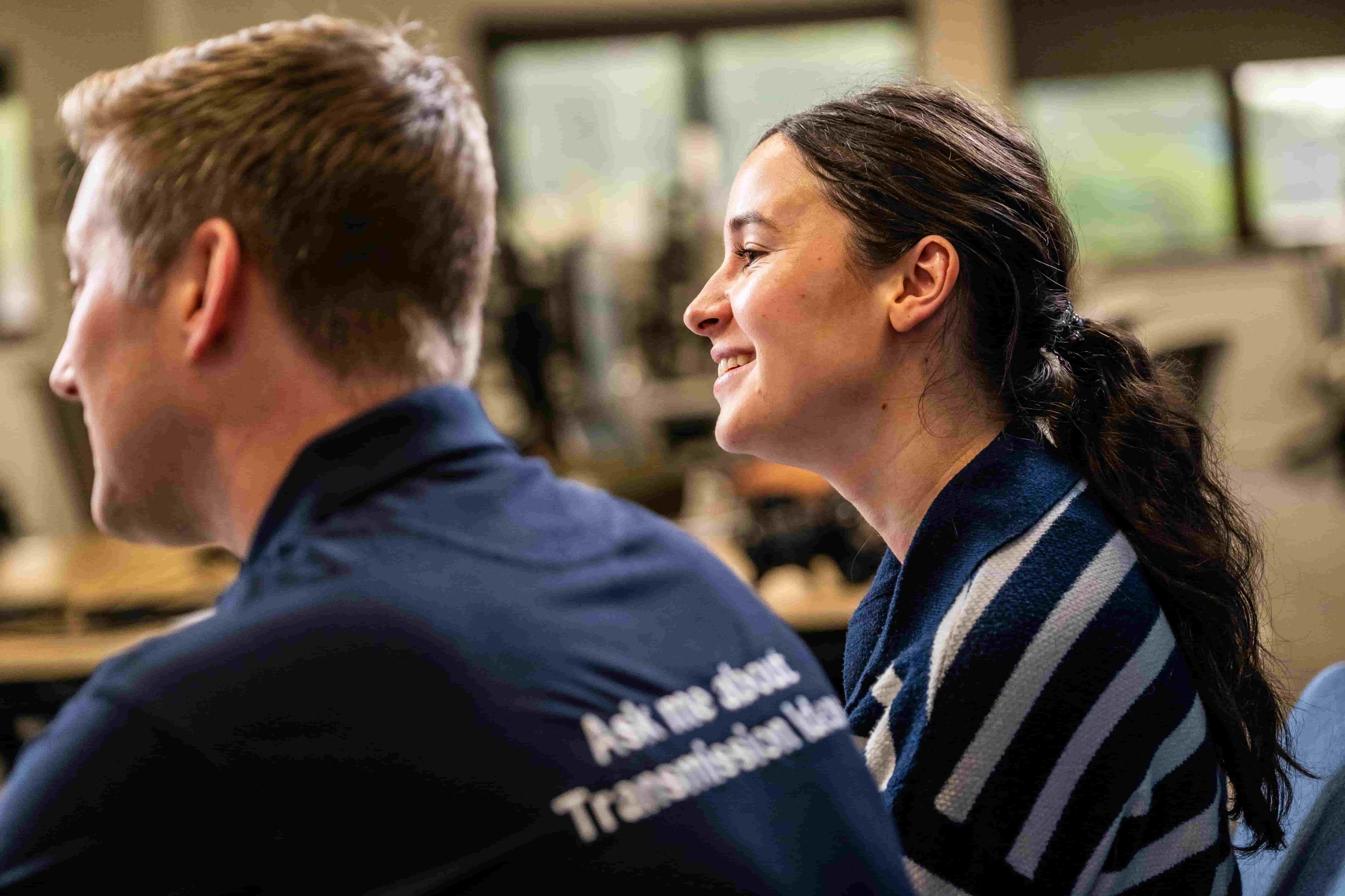 Two colleagues smiling and looking away from camera