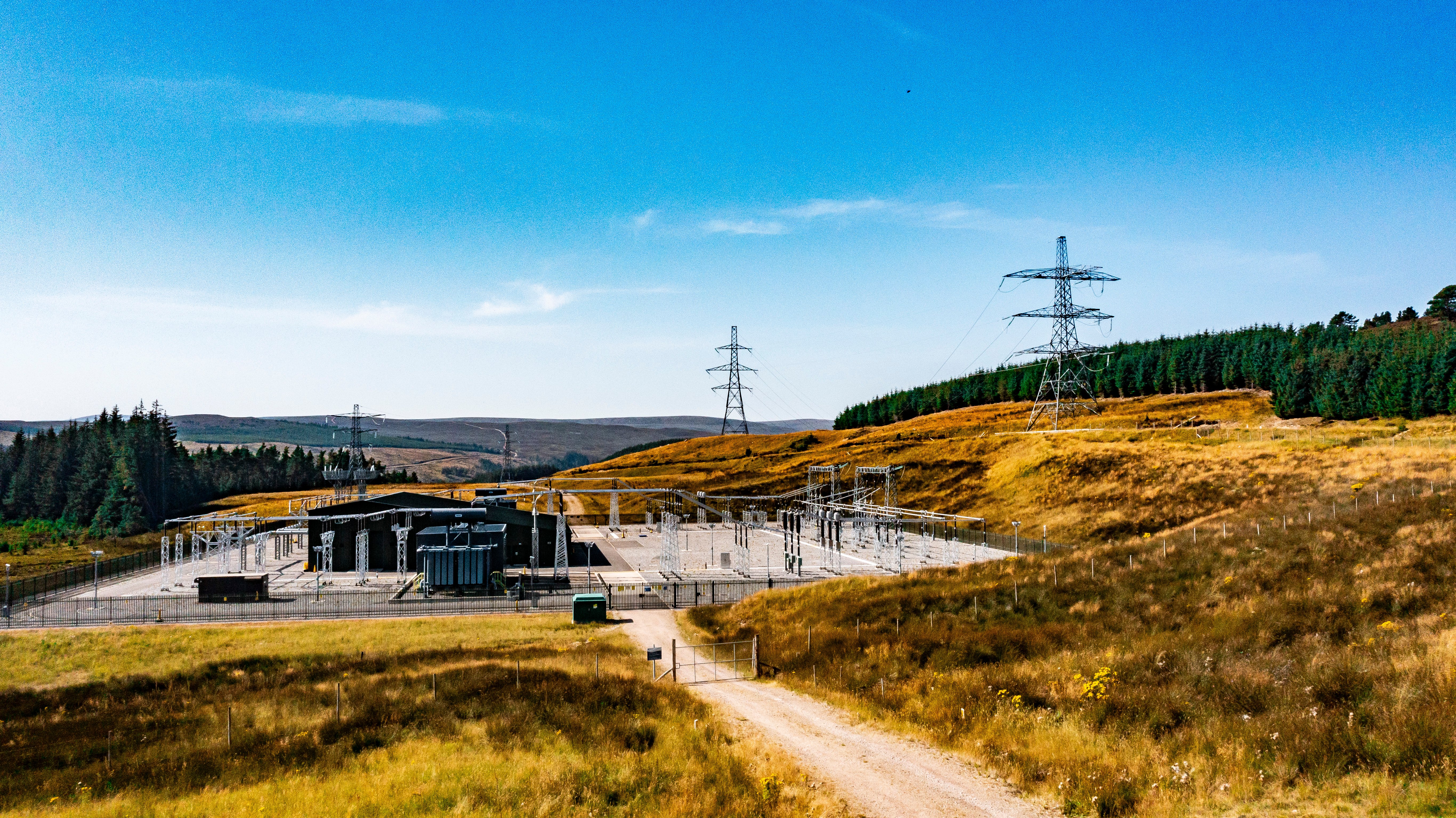 Substation with steel lattice towers in the background