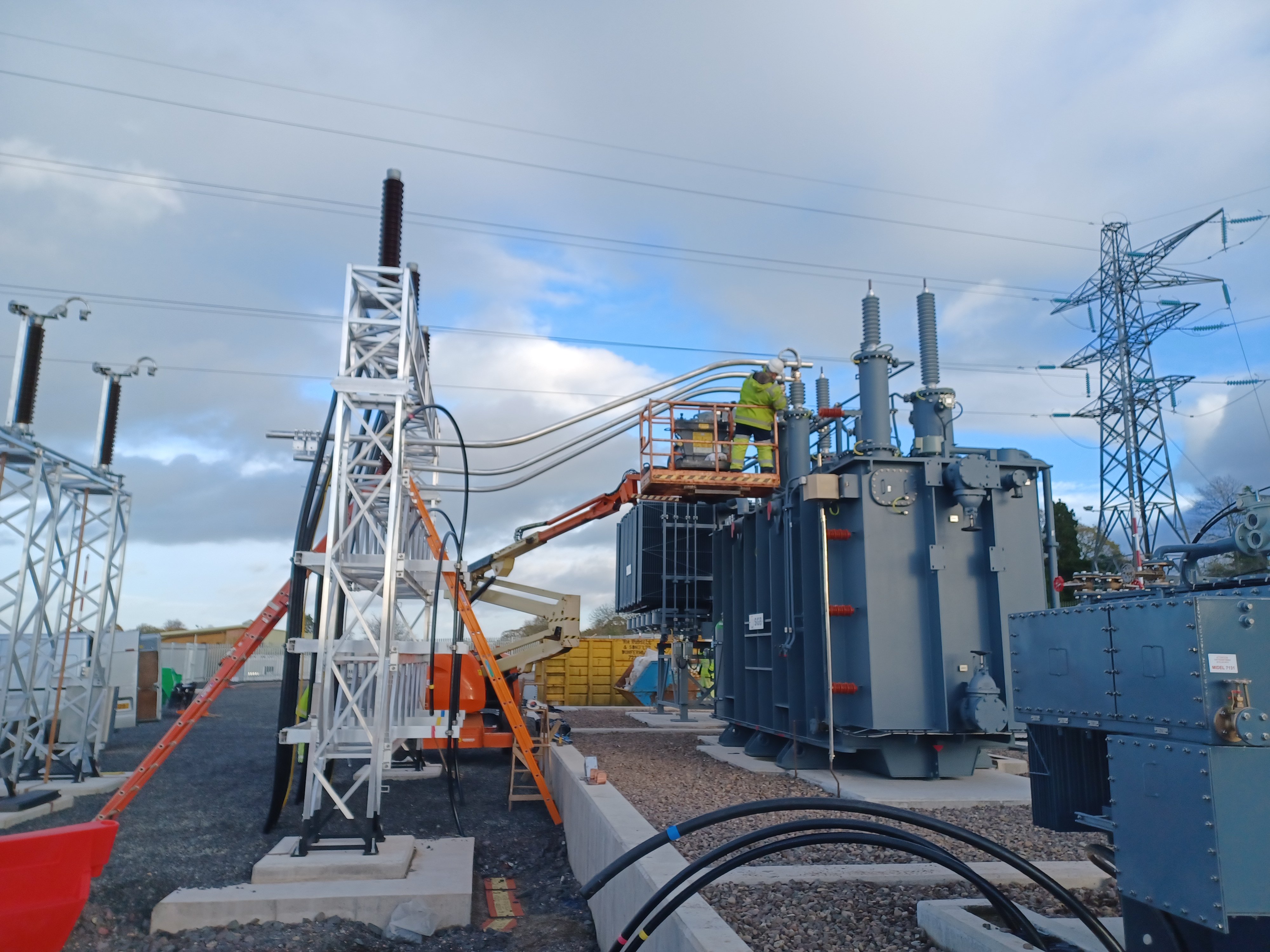 Worker carrying out works on substation.