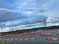 A gravel construction area with construction materials
