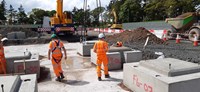 Contractors wearing PPE on site.