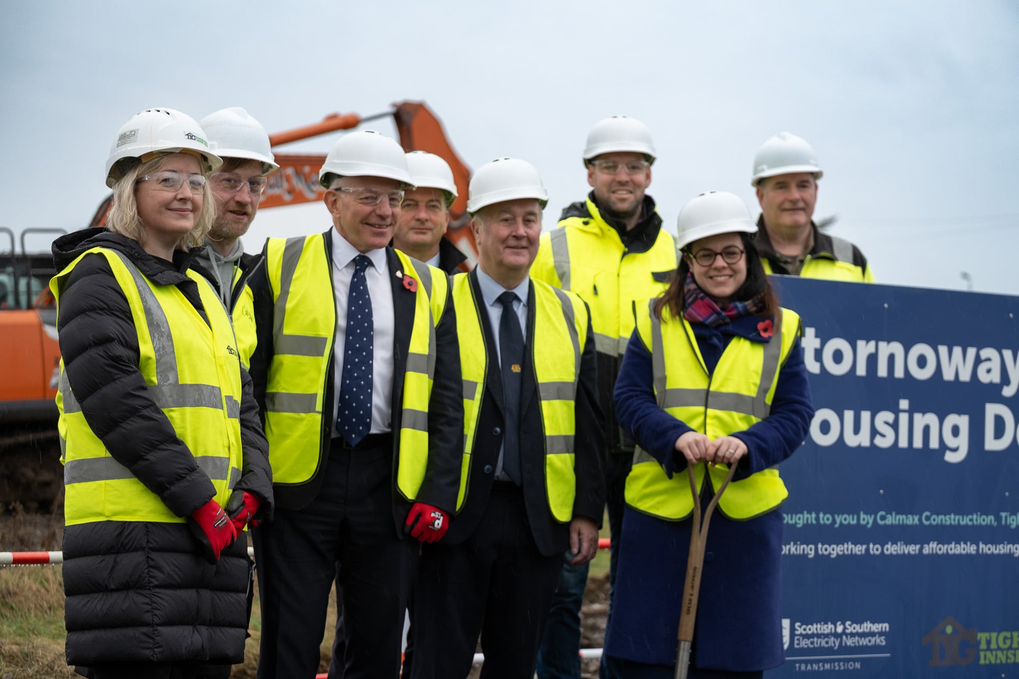 Deputy first minister with SSEN Transmission employees and key stakeholders, wearing safety equipment.