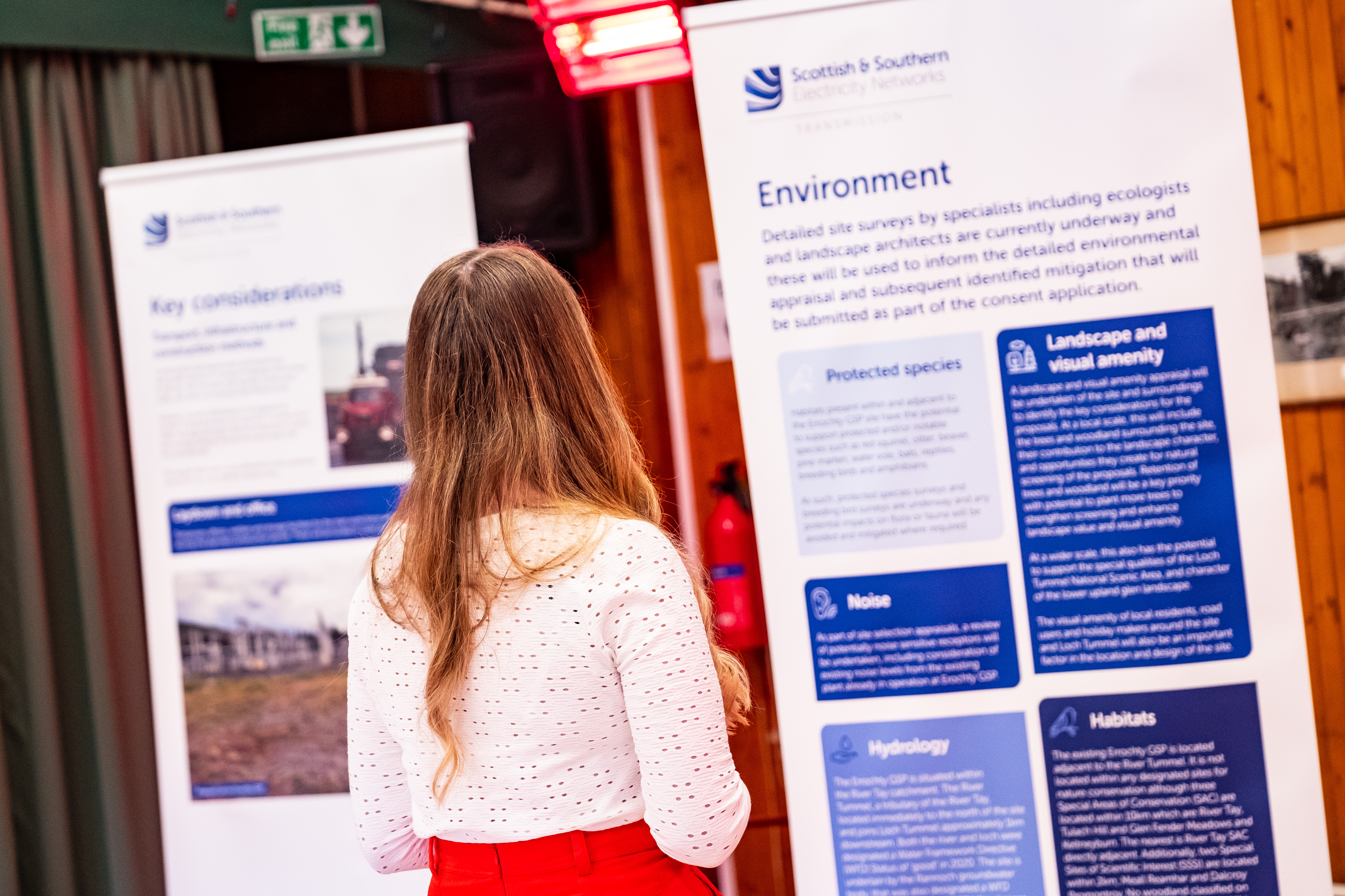 A member of the public examining a project poster.