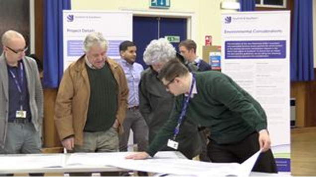 SSEN transmission employees with members of the public examining project materials.