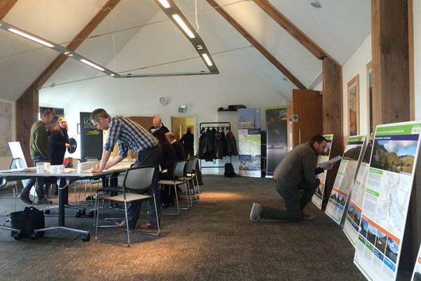 Stakeholders reviewing project plans in a hall