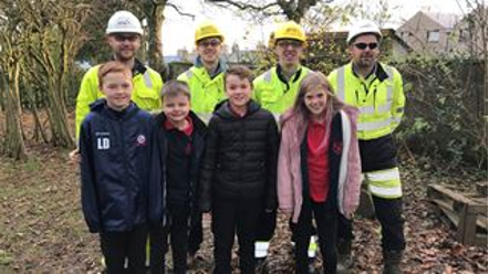 Children and engineers stood for a picture