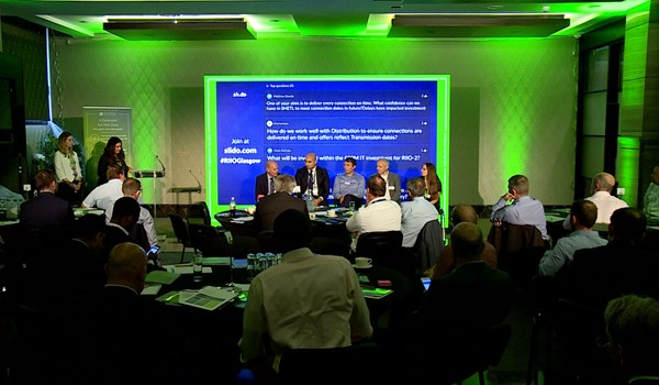 Stakeholders at a conference observing a panel