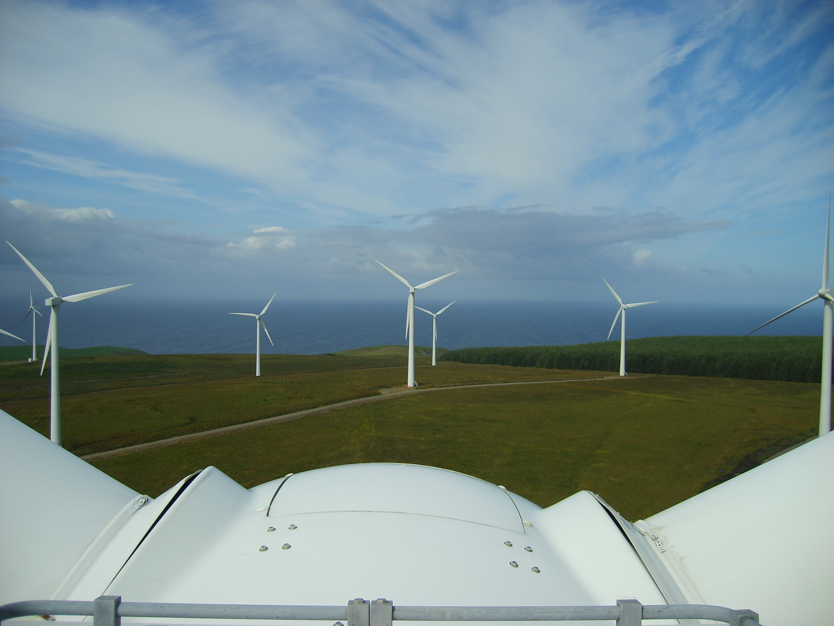 View of windfarm from atop a wind turbine hub.