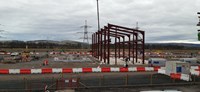 A metal framed building under construction on a construction site.