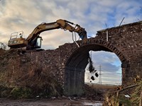 Rock breaker on arch.