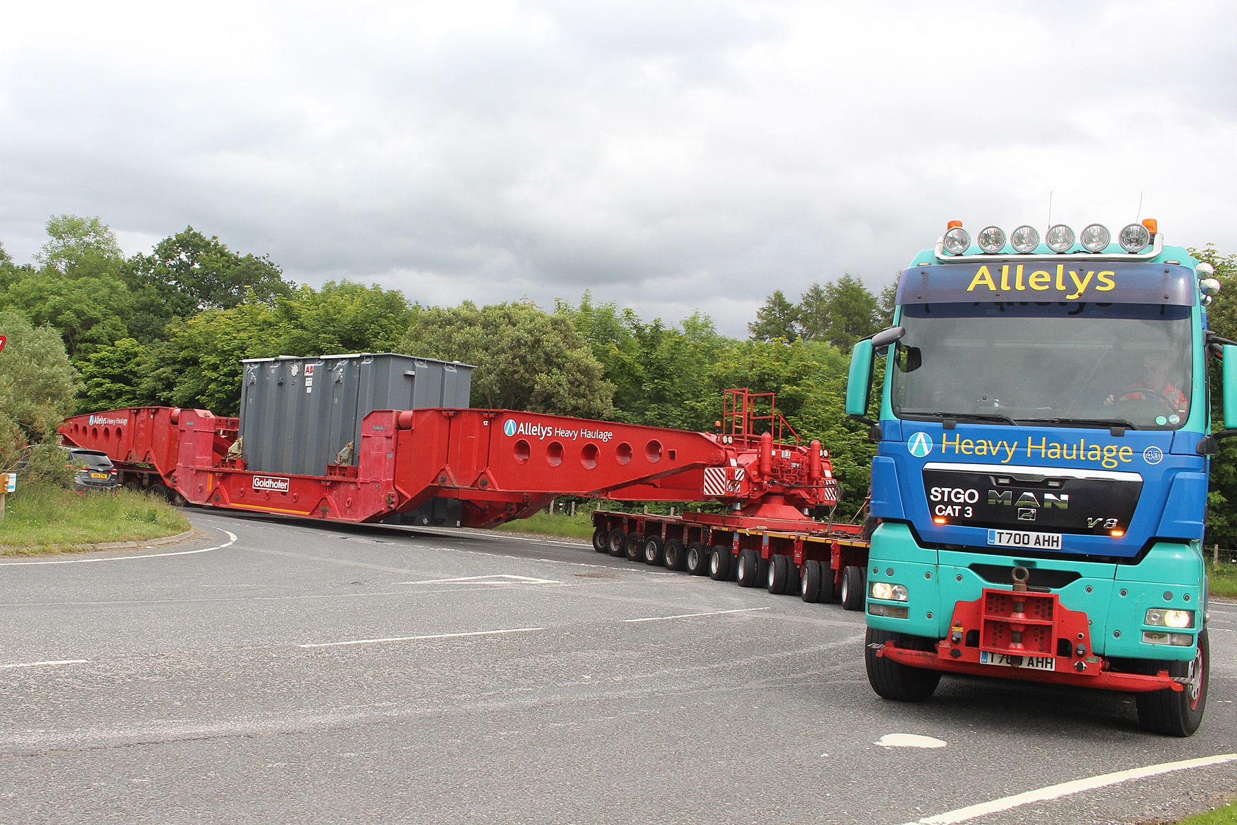 Container being transported through back roads.