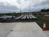 Metal structures rested on blocks on a construction site.