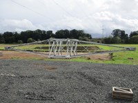 A section of transmission tower resting on the ground.