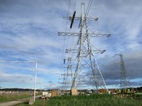 Horizontal platforms suspended from the arm of a series metal transmission towers. Wooden clad cylinders are at the base of the towers. A date in the corner states "2021/11/01 14:14"