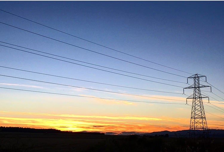 View of tower with sun setting in background.