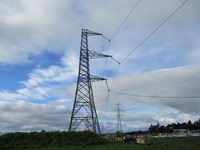 A metal transmission tower, 3 structural arms extending from one side.