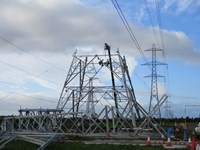 A metal transmission tower under construction.