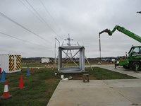 A condensed stack of metal transmission tower sections.