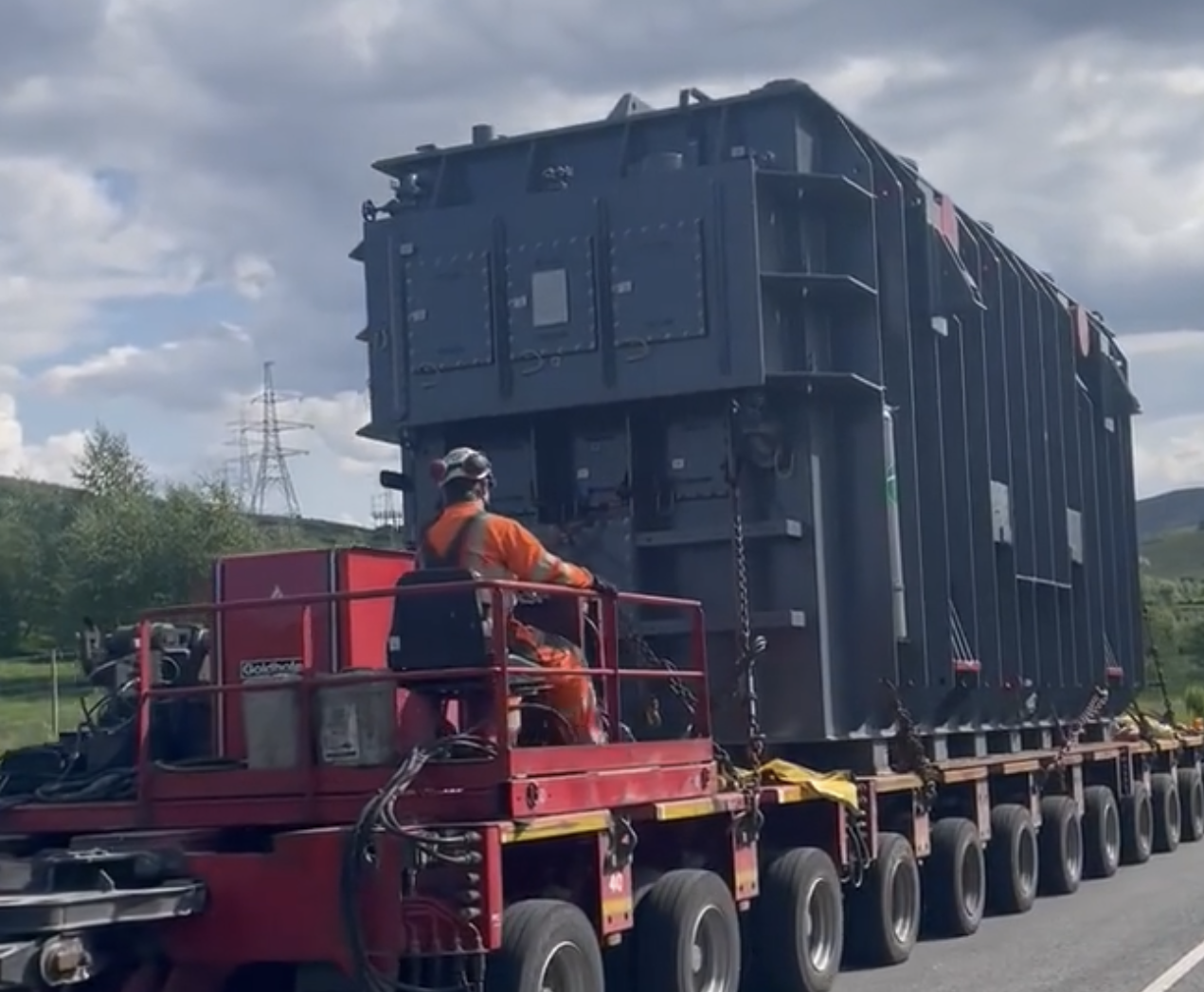 Worker on vehicle transferring  container.