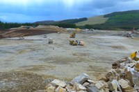 A flat rocky platform with construction vehicles.