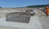 Metal-framed cuboids on a construction site.