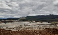 A flat rocky platform with construction vehicles.