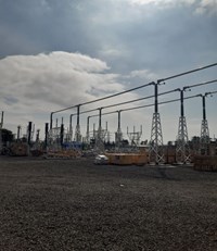 Substation infrastructure surrounded by wooden crates.