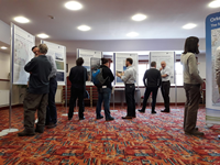 Members of the public with SSEN Transmission staff at tables in front of project posters.