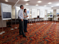 Members of the public with SSEN Transmission staff in front of a large map.