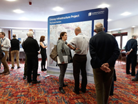 Members of the public with SSEN Transmission staff in front of a large map.