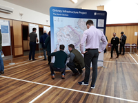 Members of the public with SSEN Transmission staff in front of a large map.