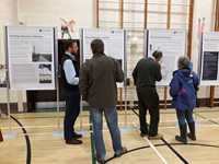 Members of the public with SSEN Transmission staff in front of project posters.