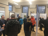 Members of the public with SSEN Transmission staff in front of project posters.