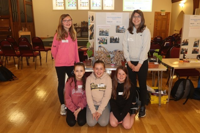 Children in front of a school project poster.