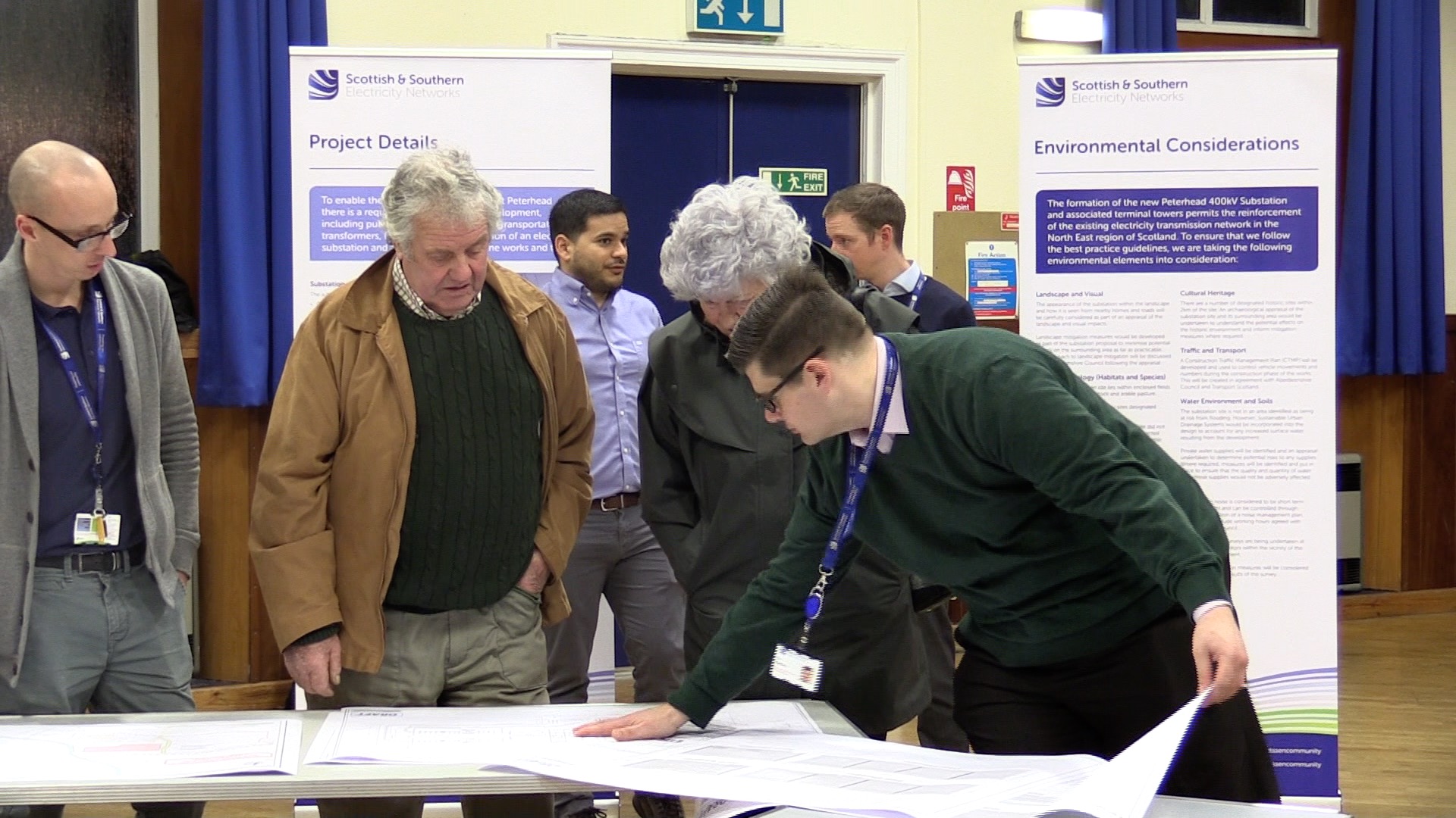 SSEN transmission employees and members of the public examining maps.