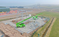 A metal transmission tower under construction.