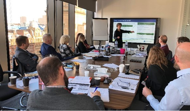 User group in boardroom during a presentation