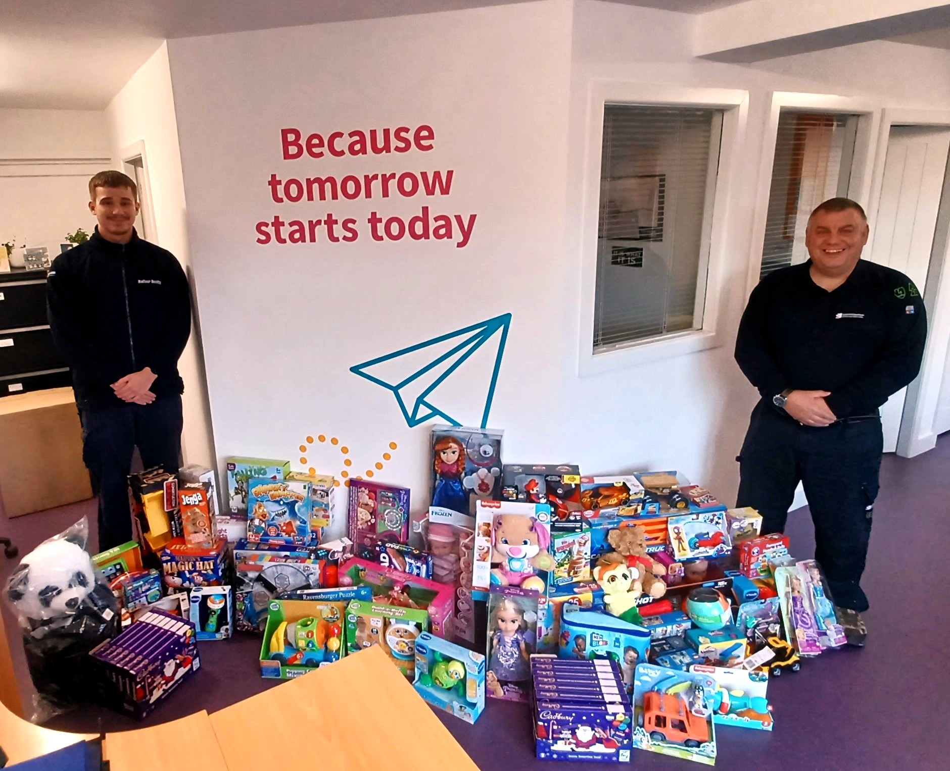 SSEN transmission employees with a pile of chocolate and toys.