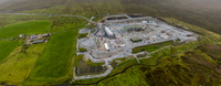 An aerial view of a substation under construction in a rural area.