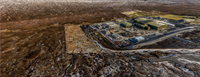 An aerial view of a substation under construction in a rural area.