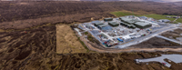 An aerial view of a substation under construction in a rural area.