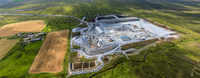 An aerial view of a substation under construction in a rural area.