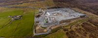 An aerial view of a substation under construction in a rural area.