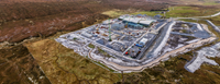 An aerial view of a substation under construction in a rural area.