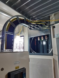 Cabling attached to a metal section of inner wall.