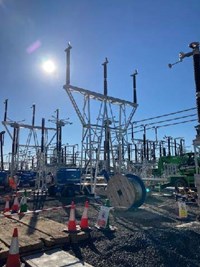 Substation infrastructure surrounded by construction equipment.