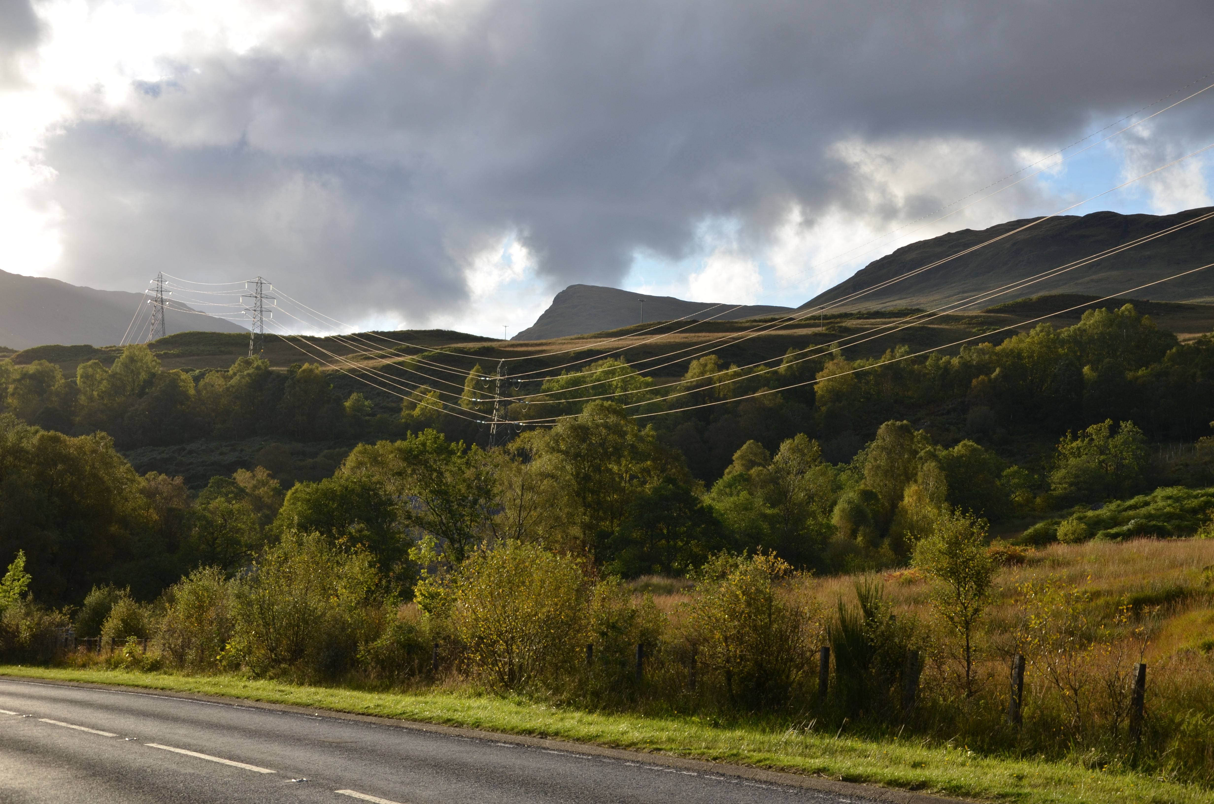 A series of metal transmission towers forming an overhead line.